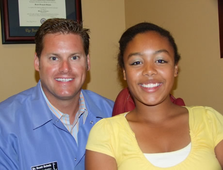 Dentist and happy patient are smiling