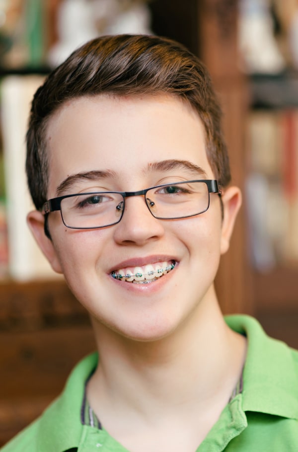 Make Your Orthodontic Treatment a Success – Tips for the Best Results. A boy is smiling