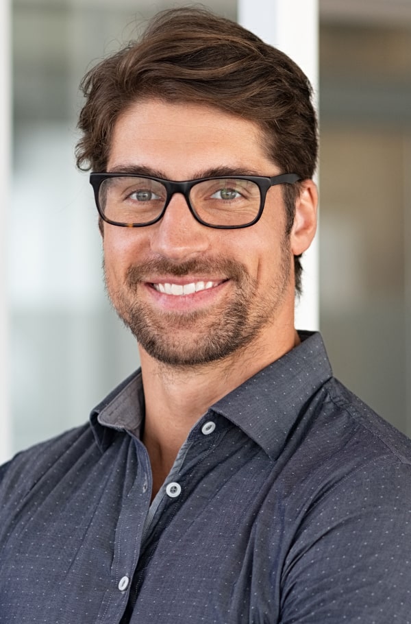 Achieve the Perfect Smile and Better Function with Advanced Treatment. A man is joyfully smiling on the street