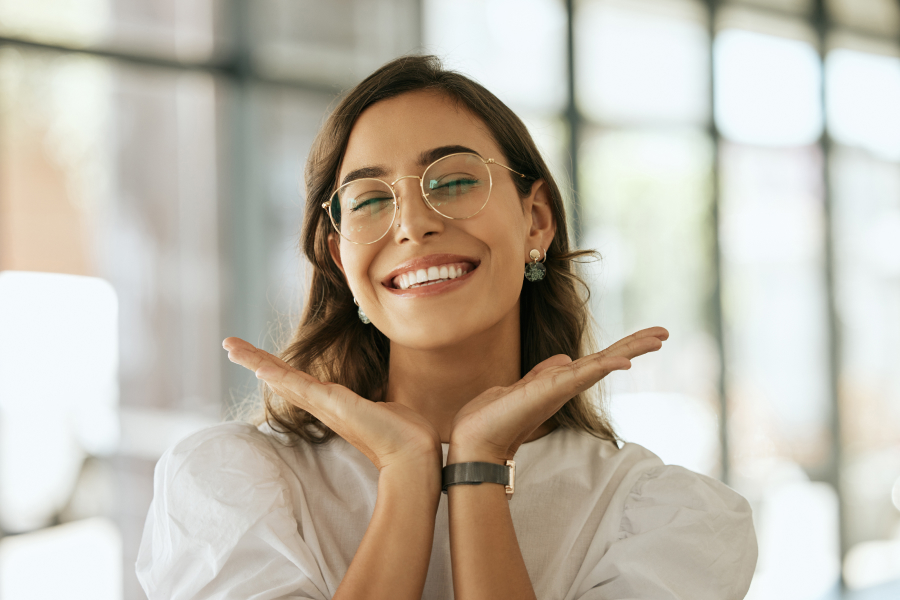 What You Need to Know Before You Decide. A woman is joyfully smiling with two hands near her face