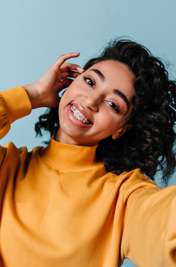 Understand the Importance of Orthodontic Treatment for a Healthier, Straighter Smile. A woman is smiling