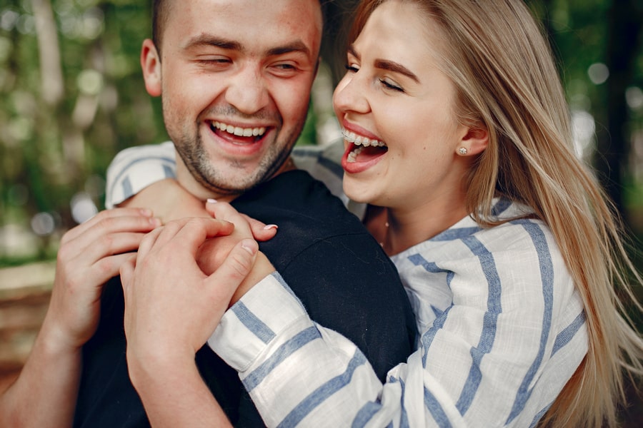 Boost Your Rewards – Earn Extra Tokens Easily! Happy couple is hugging and smiling