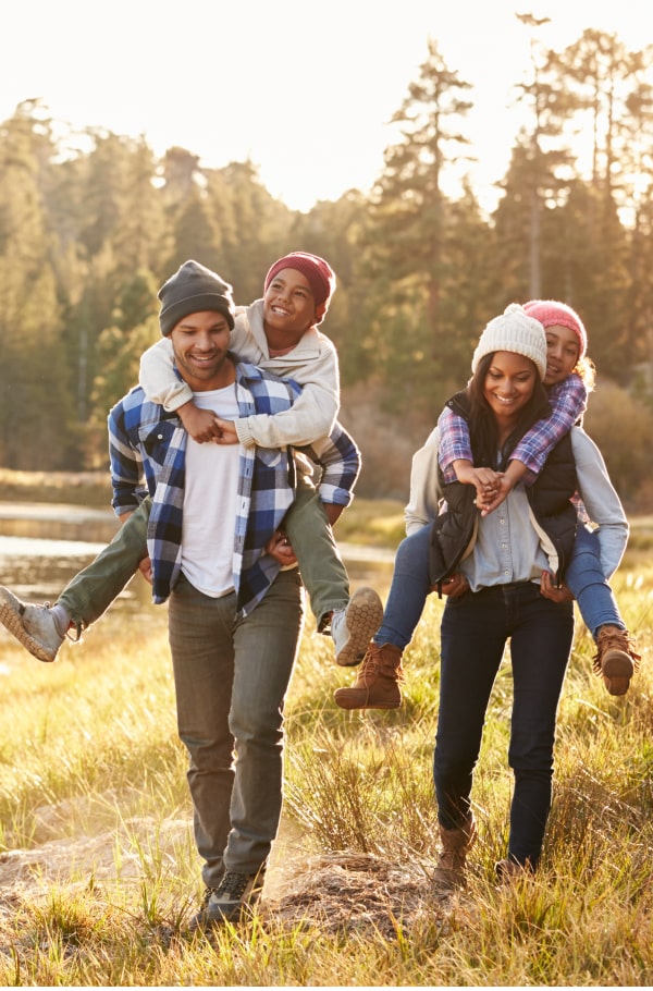 Discover How Early Orthodontic Treatment Can Benefit Your Child’s Smile. Happy family of four in the nature